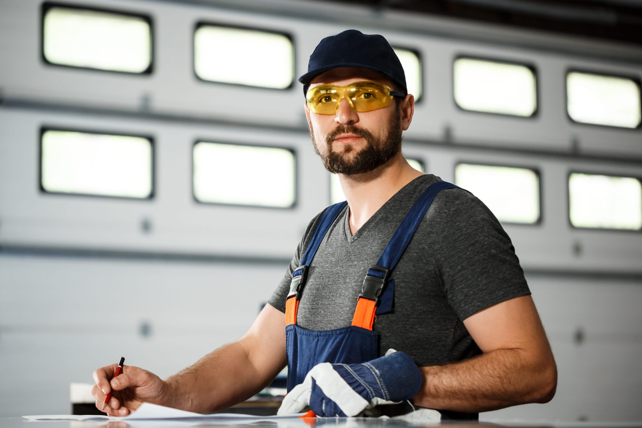 portrait-worker-overalls-steel-factory-background-min