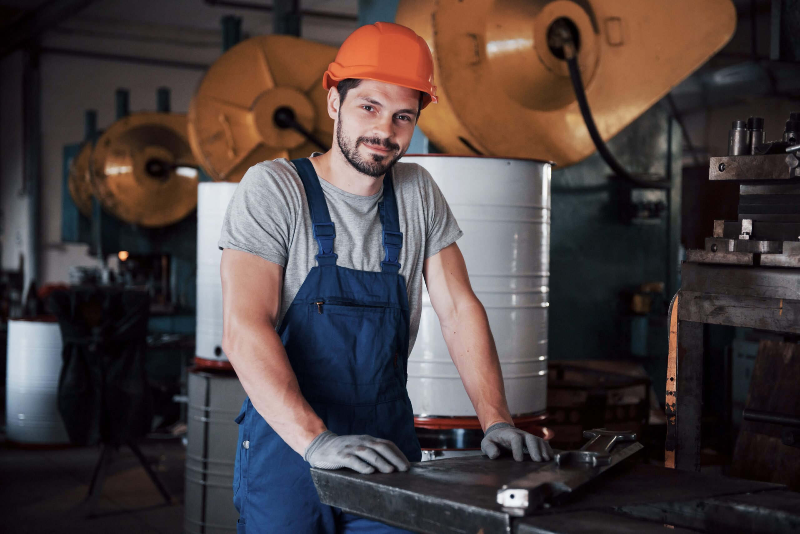 portrait-young-worker-hard-hat-large-metalworking-plant-min