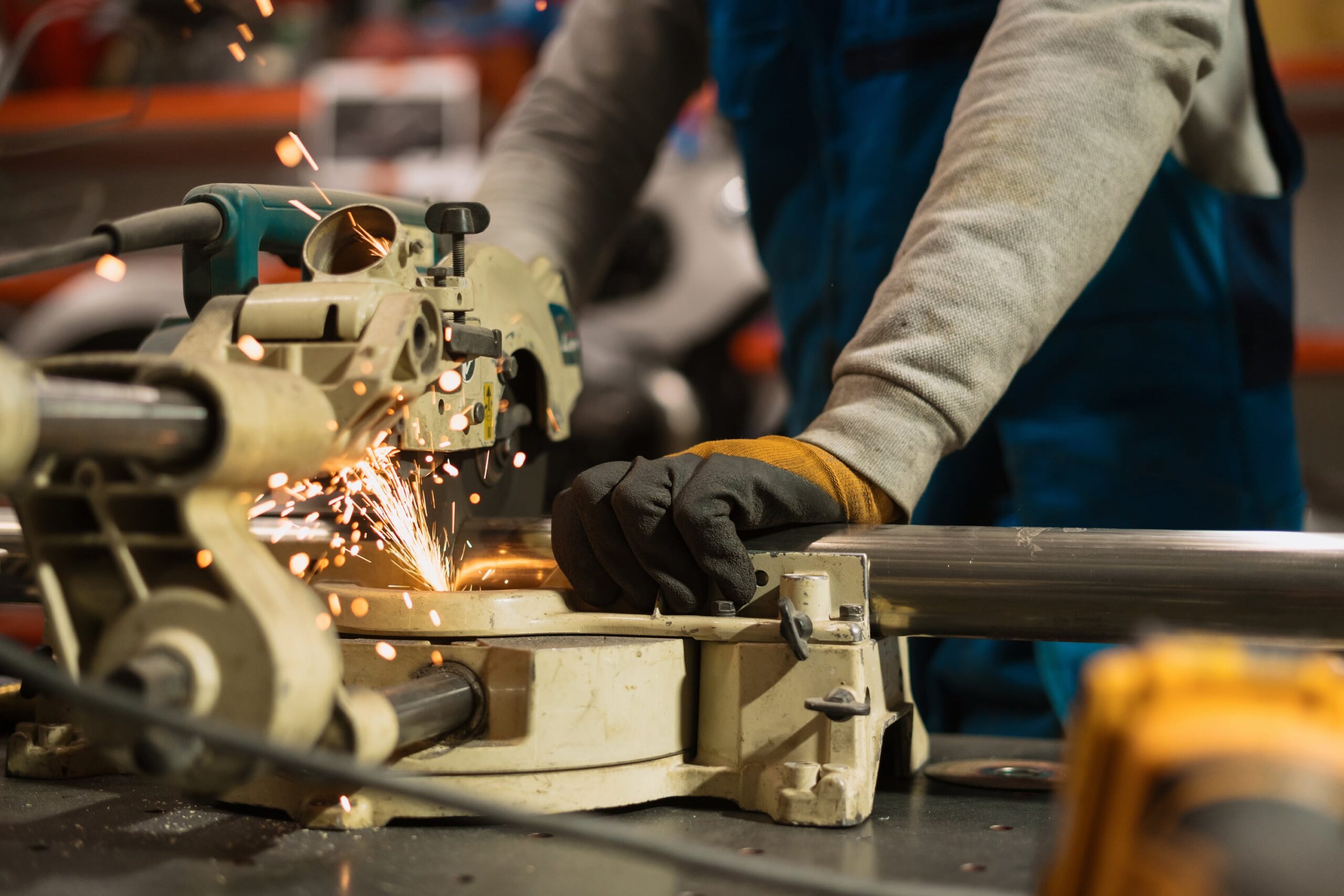 worker-working-with-circular-grinder-metal-with-sparks-min